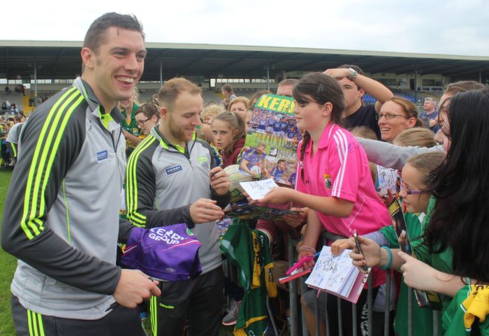 Kate O'Connor from Gortatlea leans over to get Darren O'Sullivan's autograph while David Moran enjoys a joke with fans at the Kerry Supporters Open Day at Fitzgerald Stadium on Saturday. Photo by Dermot Crean