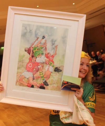 Maureen Fleming holds the painting of Kieran Donaghy which was auctioned off and bought by Eoin Liston at the 'Kerry GAA Stars Lovely Legs Competition' at the Fels Point Hotel on Saturday night. Photo by Dermot Crean