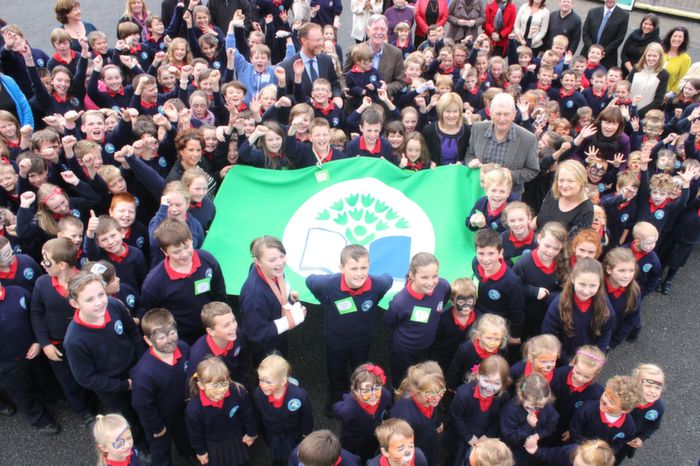 Pupils of Listellick Primary School celebrate the raising of the Green Flag presented to them by An Taisce. Photo by Gavin O'Connor. 