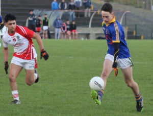 Michael Reidy of CBS The Green strides forward watched by Martin O'Gorman of Pobalscoil Chorca Dhuibhne during the Corn Uí Mhuirí Quarter-Final clash on Wednesday at Dr Crokes GAA grounds. Photo by Fergus Dennehy