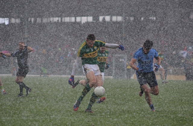 With hail stones teaming down, David Moran, grabs the game by the scruff of the neck and pings the ball over the bar for Kerry. Photo by Dermot Crean. 