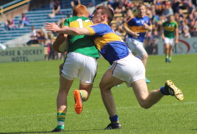 A Tipperary player's chin gets introduced to Johnny Buckley's shoulder. Photo by Dermot Crean. 