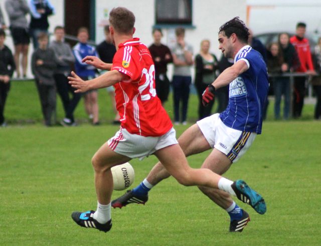 Cormac Coffey, fires a shot at goal, while East Kerry's, James McCarrick, attempts to get close. Photo by Dermot Crean. 