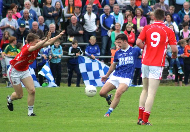 Jack Savage, fires a shot at goal, while East Kerry's James O'Donoghue, attempts a block. Photo  by Dermot Crean. 