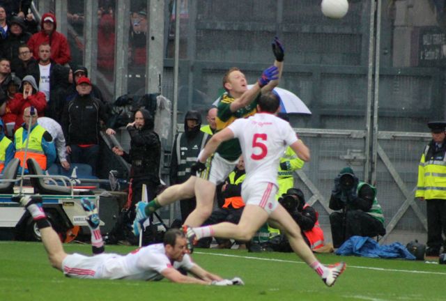 Colm Cooper, veering goal is tripped and about to sustain a disgusting tackle from Ronan McNabb. Photo by Gavin O'Connor.