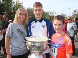 Karen and Tiernan O'Carroll with Kerry minor Jack Morgan and the Tommy Markham Cup at the CBS 5k and 3k Fun Run at the school on Sunday. Photo by Dermot Crean