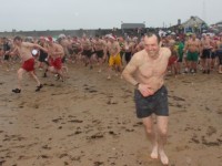 Let's go again...making the dash into the water for the Christmas Day swim in Fenit. Photo by Dermot Crean