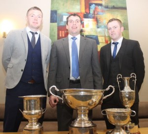 Captain of the 2015 Kerry County Championship winning team Sean Maunsell, Chairman of Kilmoyley GAA Club Joe Walsh and captain of the Kerry team Daniel Collins with the Neilus Flynn Cup, the Division 2 League trophy won by Kerry, the Christy Ring Cup and the Minor B All-Ireland trophy at the Kilmoyley GAA social at the Ballyroe Heights Hotel on Saturday night. Photo by Dermot Crean
