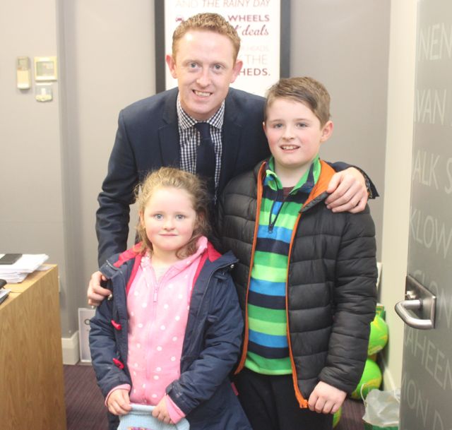 Colm Cooper with Thomas and Laura Keane, Knocknagoshel, at the fun day at AIB in Castle Street, Tralee, on Tuesday. Photo by Dermot Crean