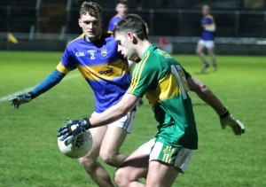 Jack Savage of Kerry is watched by Tipperary's Colm O'Shaughnessy. Photo by Dermot Crean
