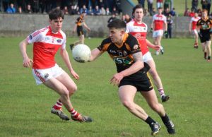 David Mannix on the attack as Tomas Leo O Suilleabhain prepares to give chase during the Austin Stacks v Dingle match in Annascaul on Saturday evening. Photo by Dermot Crean