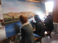 Tralee Art Group members and KDYS students working on a mural for Baile Mhuire Day Care Centre.
