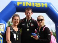 Niamh Moriarty, Gary Savage and Niamh Switzer at the Dingle Way Challenge finishing line. Photo by Gavin O'Connor.