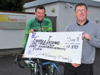 Tommy Sheehy hands over a cheque of €10,870 to Sean Scally of Enable Ireland. Photo by Gavin O'Connor.