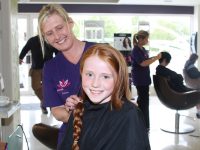 Hairdresser at Expose, Joanne Lynch, with the lock of hair Roisin Sugrue has donated to the Chernobyl Children's Project International. Photo by by Gavin O'Connor.