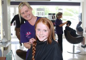 Hairdresser at Expose, Joanne Lynch, with the lock of hair Roisin Sugrue has donated to the Chernobyl Children's Project International. Photo by by Gavin O'Connor. 