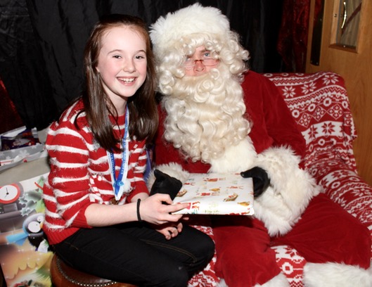 Sophie Hassett with Santa at the Kerins O'Rahillys Christmas Fair on Sunday afternoon. Photo by Dermot Crean