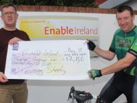 Sean Scally of Enable Ireland Kerry Services accepts a cheque for €12,186 from Tommy Sheehy. Photo by Dermot Crean