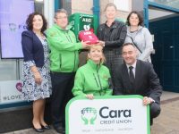 Jimmy Murphy of Tralee Community Responders accepts the new defibrillator from Caroline Sugrue of Cara Credit Union board of management. Also included, standing, from left; Siobhan Donnelly of Cara Credit Union and Carmelia Draghici of Tralee Community Responders. Kneeling is Julie O'Sullivan of Tralee Community Responders and Pa Laide, CEO of Cara Credit Union. Photo by Dermot Crean