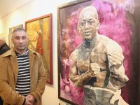 Mikel Mato with his painting of boxer Jack Johnson at the opening of the 'Off The Rails' exhibition in Kerry County Museum on Thursday night. Photo by Dermot Crean
