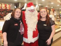 Ciara Lynch and Meghan Galvin with Santa at the Garvey's Supervalu Tralee Christmas Food Fair on Wednesday evening. Photo by Dermot Crean