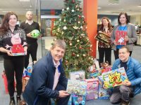 In front; Junior Locke and Paddy Kevane of St Vincent de Paul collect toys and donations from JRI America staff at their Tralee offices on Friday morning. Included at back are members of the JRI America Charity Committee Vicky Coates, Gregory Hérvé, Mary Campion and Mairead Mullen. Photo by Dermot Crean