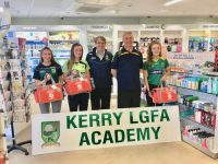 Morgan O'Connell of O'Connell's Pharmacy presenting medical kits to Rory Kilgallen, Director of Kerry Ladies Football Academy, with players Aisling O'Connell, Rachel Kilgallen and Lauren Smullen.