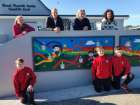 Jennifer Boyle & John Keane (Parent Council members) with Terence Dineen (Principal) and Lisa Harkin look on as Luke Boyle. George &Sam Keane admire Lisa's painting with John Hume's words 'The answer to difference is to respect it'.