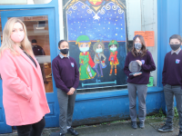 Art teacher Mary J Leen with Coláiste Gleann Lí pupils at their decorated shopfront at Castle Street (old Utensils shop). Photo by Dermot Crean