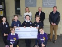 Blennerville pupils holding the cheque they presented to Con O'Connor (back centre) of Pieta House on Tuesday. Also included is teacher Catherine Moynihan and Principal Robbie O'Connell. Photo by Dermot Crean