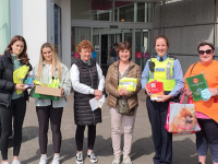 Members of the public meet with a Garda outside Manor West Shopping Centre on National Community Engagement Day.
