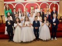 Teacher Aoileann de Hóra, Fr Sean Jones and Principal Mary Connolly with second class pupils at the Caherleaheen NS First Holy Communion Day at the Church of the Immaculate Conception on Saturday. Photo by Dermot Crean