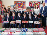 Members of the Scoil Eoin Student Council, with Mrs Carol O'Donoghue, SNA Grace Hobbert, and Kieran O'Toole with all the shoeboxes collected in aid of Team Hope.