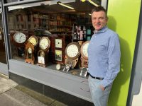 James O'Donoghue with the antique clocks gracing his pharmacy window in Boherbee. Photo by Dermot Crean