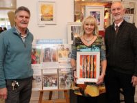 Artist Maree O'Connor with Paul Hanrahan and David Buttimer of Action Lesotho at Maree's art sale/exhibition at The Daily Grind on Friday. Photo by Dermot Crean
