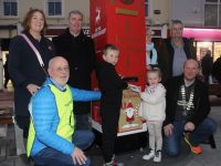 Callum and Hannah O'Halloran posting their letters in the Tralee Rotary Club's Santa's Postbox on Saturday in The Square. Also included are Grace O'Donnell, John Moriarty, Michael Lynch, Catherine and Harry Hynes and Tralee Rotary President Michael Slattery. Photo by Dermot Crean