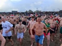Making the dash at the Christmas Swim in Fenit on Sunday. Photo by Dermot Crean