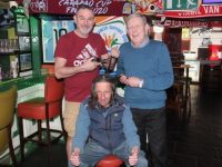 Aidan Griffin (seated) will be getting his long locks chopped off at a fundraising event at The Huddle Bar next week. Also included is Paul Lowth and Pat Herlihy from The Huddle Bar. Photo by Dermot Crean