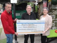 Aidan Griffin presents €705 to Breda Dyland of the Kerry Cancer Support Group, the proceeds from a charity headshave in The Huddle Bar last weekend. Also included is Pat Herlihy, Manager of The Huddle Bar. Photo by Dermot Crean