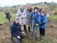 Tralee Educate Together pupils with Rachel Geary of LEAF, teacher Treasa Browne and Sinead Fitzgerald planting trees at the Wetlands on Tuesday. Photo by Dermot Crean