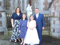 Orla Joy with sister Aine and parents Grainne and John Joy at Presentation Primary's First Holy Communion Day at St John's Church on Saturday. Photo by Dermot Crean