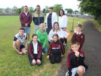 Holy Family pupils with Jamie O'Keeffe, Caroline Quill and Helen O'Keeffe and at back teachers Liam Moloney, Tommy Lyons, Principal Maria O'Regan and teacher Deirdre Harty, taking part in the Holy Family NS Coin Trail Fundraiser on Thursday. Photo by Dermot Crean