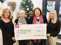Niamh Brosnan (left) and Kate Brosnan (right) present the proceeds of there recent fundraiser to Suzie Cox and Catherine Casey. Photo by Dermot Crean