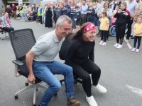 A tight contest between Cllr Cathal Foley and Angie Baily while taking part in the Office Chair Racing on Friday evening. Photo by Dermot Crean