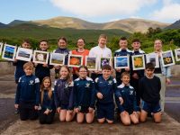 Pupils from 3rd-6th Class,   Fybough National School, Castlemaine, Co. Kerry who won the Community Champions award for their classroom business,  Photo Buddies as part of  the Junior Entrepreneur Programme 2024.  The pupils invested in Photo Buddies to photograph local beauty spots and create mounted original prints for sale.   The pupils are pictured with teacher Eileen Lovett and Principal Vanessa Clifford with some of their photographs near the foot of Caherconree and Bartregaum mountains. Photo: Jerry Kennelly | NO REPRODUCTION FEE