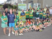 Declan Quill with his neighbours in Cluain Ard and the signs they put up in support of Kerry on Sunday. Photo by Dermot Crean